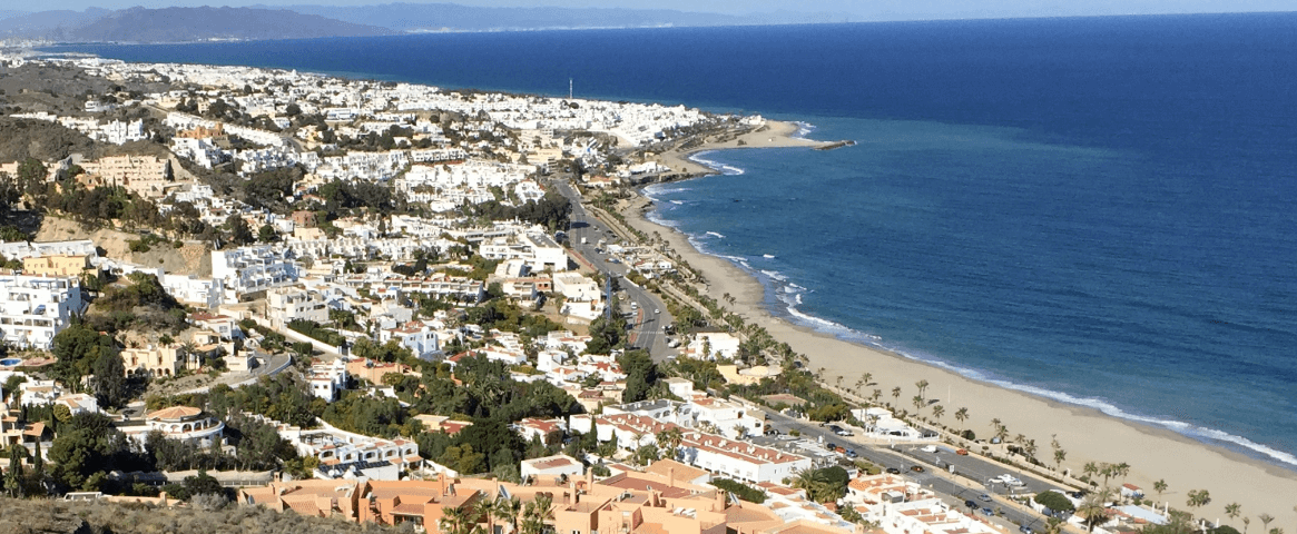 Whitewashed houses leading to blue Mediterranean sea