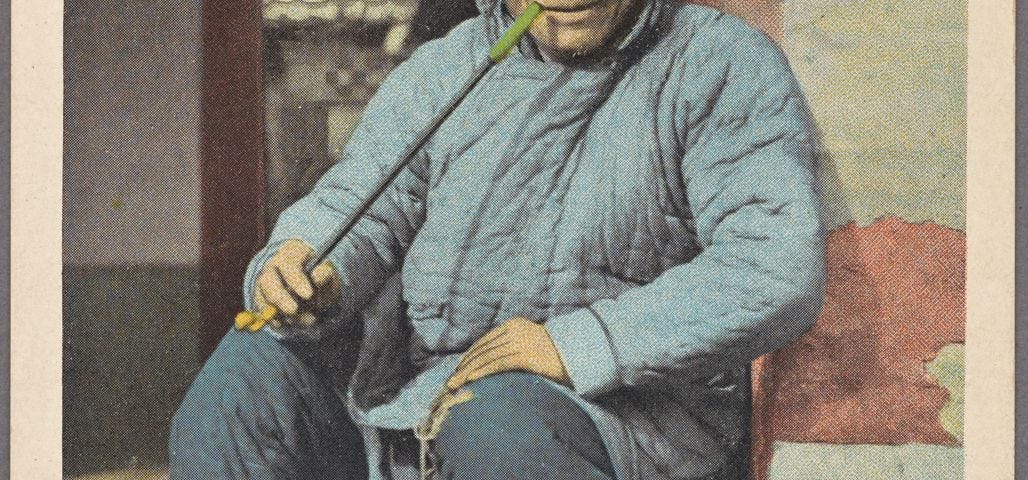 Old black and white photo (1922), post-production coloured. Chinese man with long stick pipe, looking very content. The Tao is timeless.