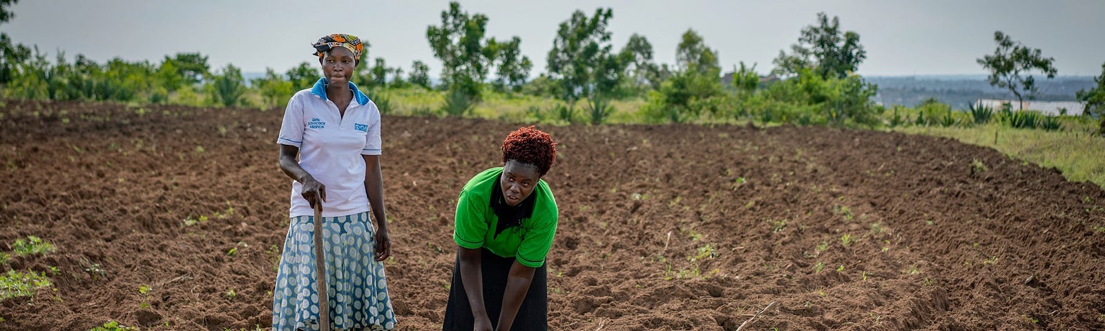 Two women working in a field.