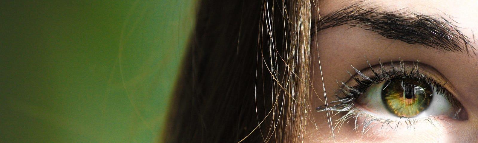 Focus half-face closeup photography of female’s green eye