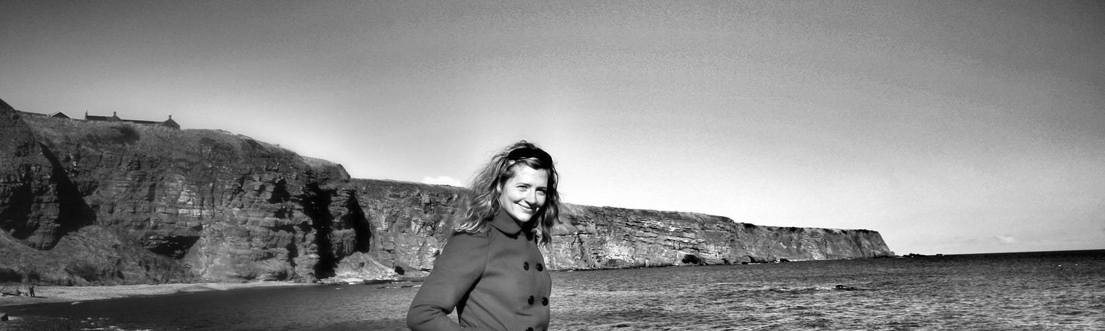 Black and white photograph of writer Dawn Geddes at Auchmithie Beach