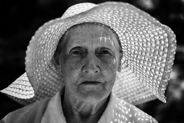 Face of old woman wearing a sunhat