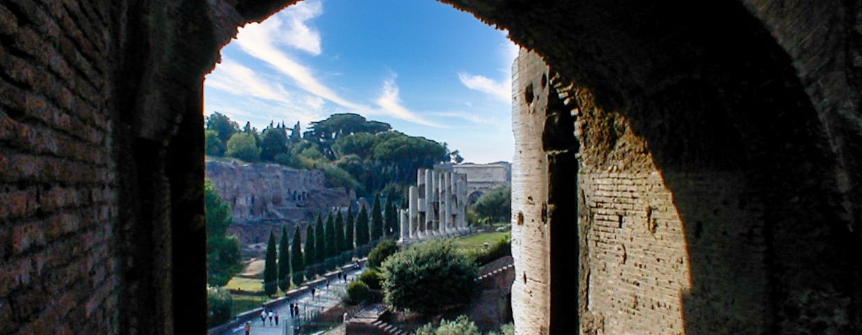 a view of Capitoline Hill from a door of the Colosseum in Rome. Italy looking out at the countryside and blue skies on a single day
