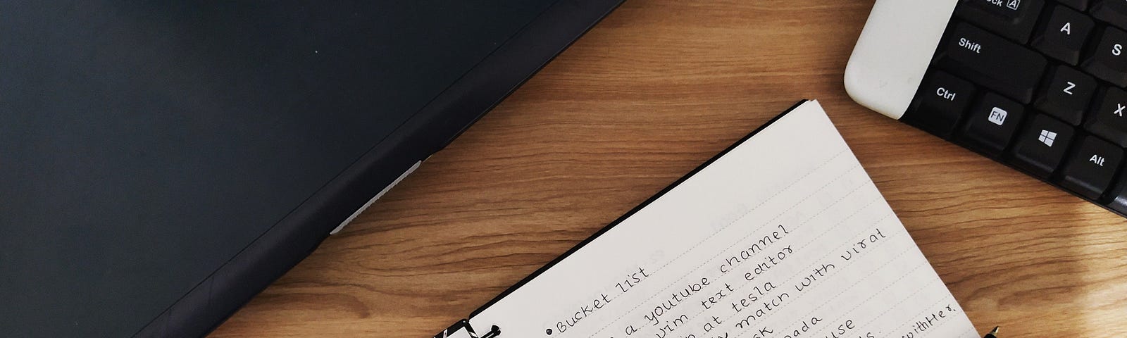 https://www.pexels.com/photo/a-pen-on-notebook-with-a-written-bucket-list-beside-a-laptop-and-keyboard-4810501/