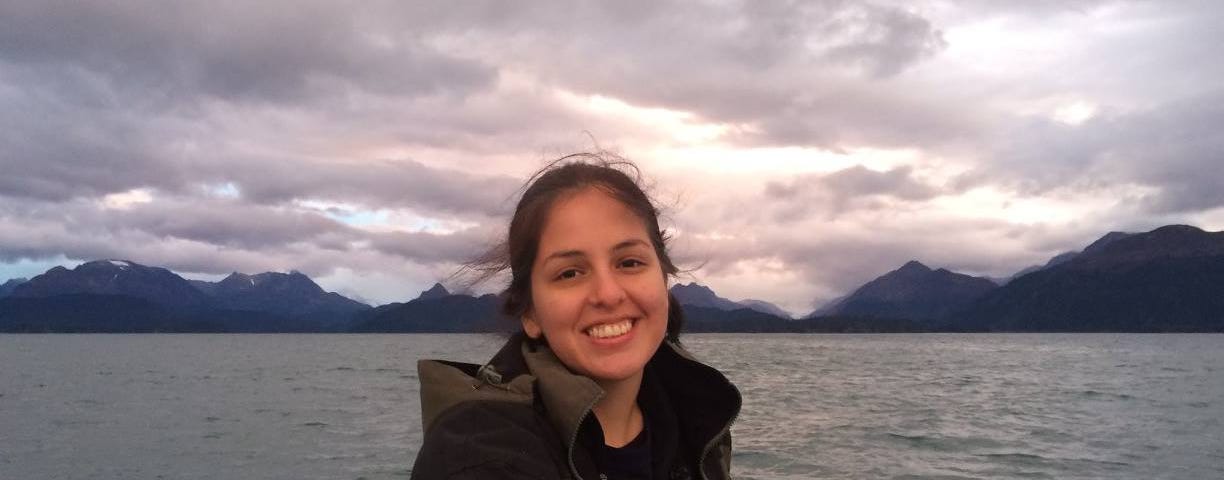 a woman smiles while sitting in a boat