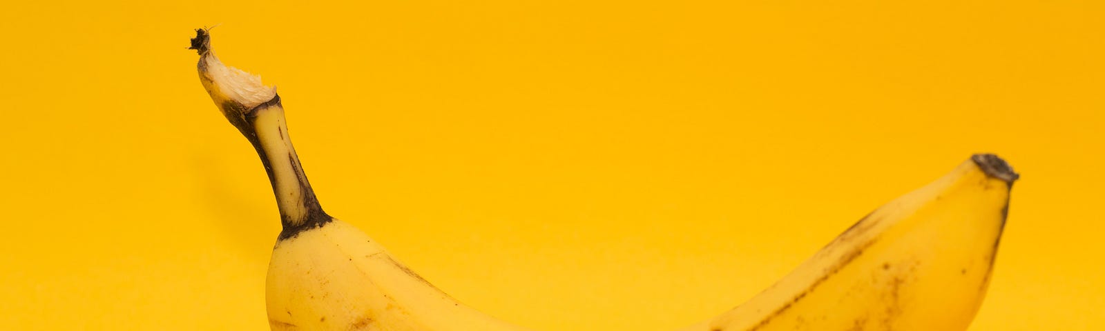 a yellow banana on a yellow background