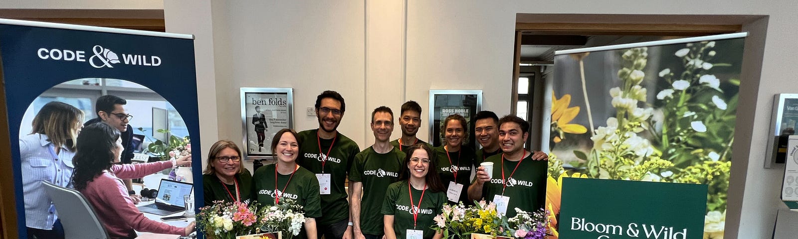 The Bloom & Wild tech team standing behind a sponsors booth at the Brighton Ruby conference 2023