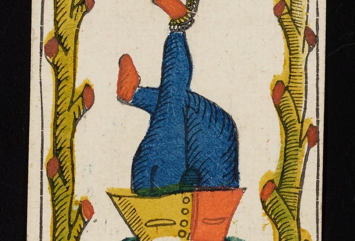 Photo of an old woodcut Tarot card image of the hanged man, a man in renaissance dress hangs upside down tied by one ankle