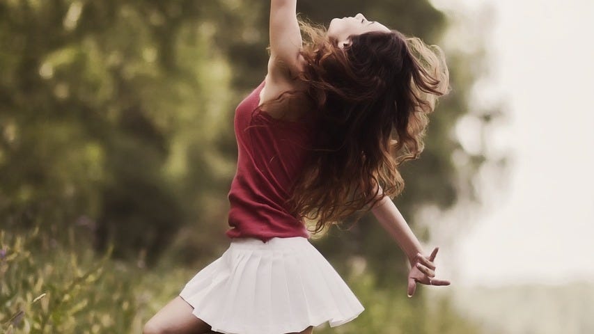 A woman dancing her way to happiness.