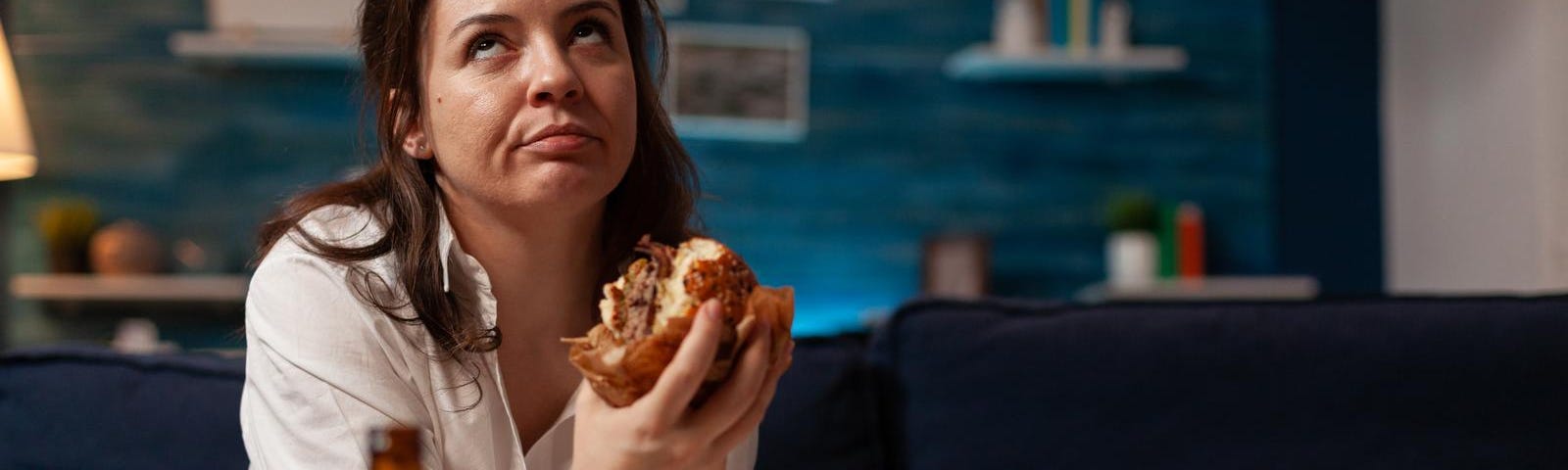 A woman eating a burger.