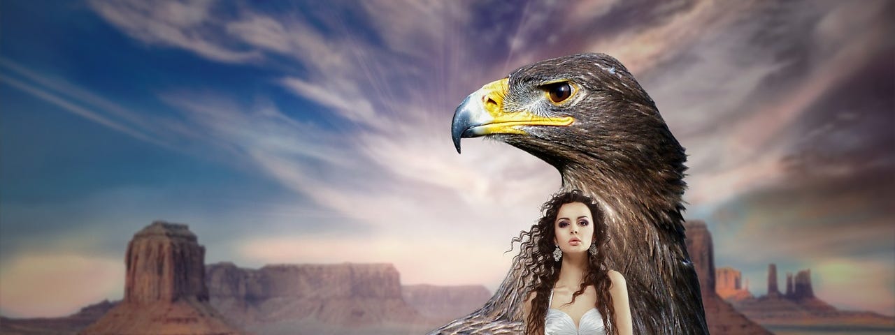 A large bald eagle and wrapped lovingly within its wings is a warrior queen.