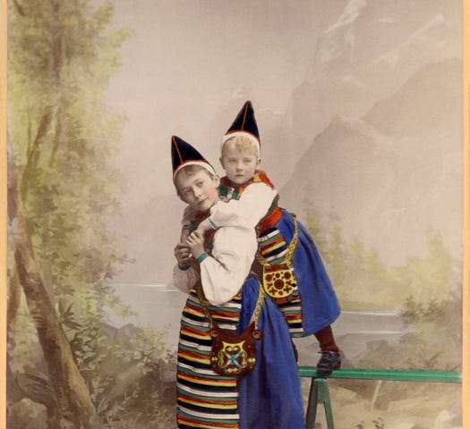 A photo of two girls of different ages, dressed in folk costumes