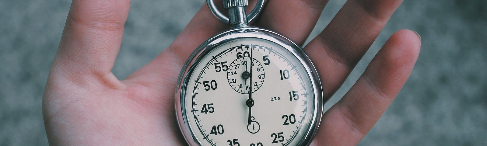 Image of hand holding time piece