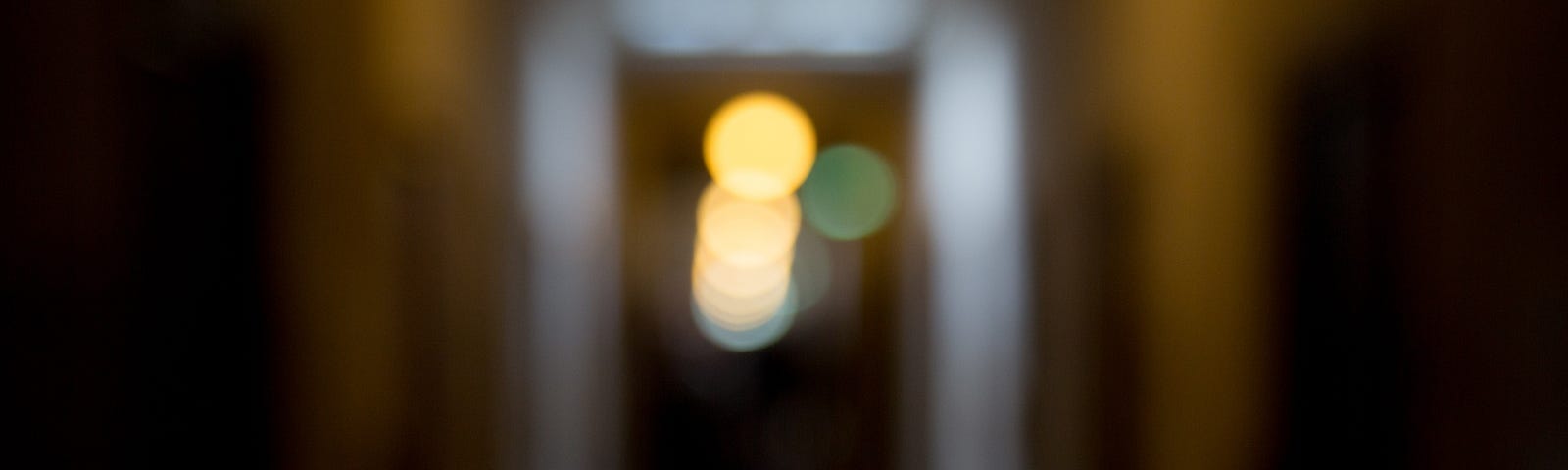 Blurry lights down an out-of-focus hallway. Worms All by Jim Latham