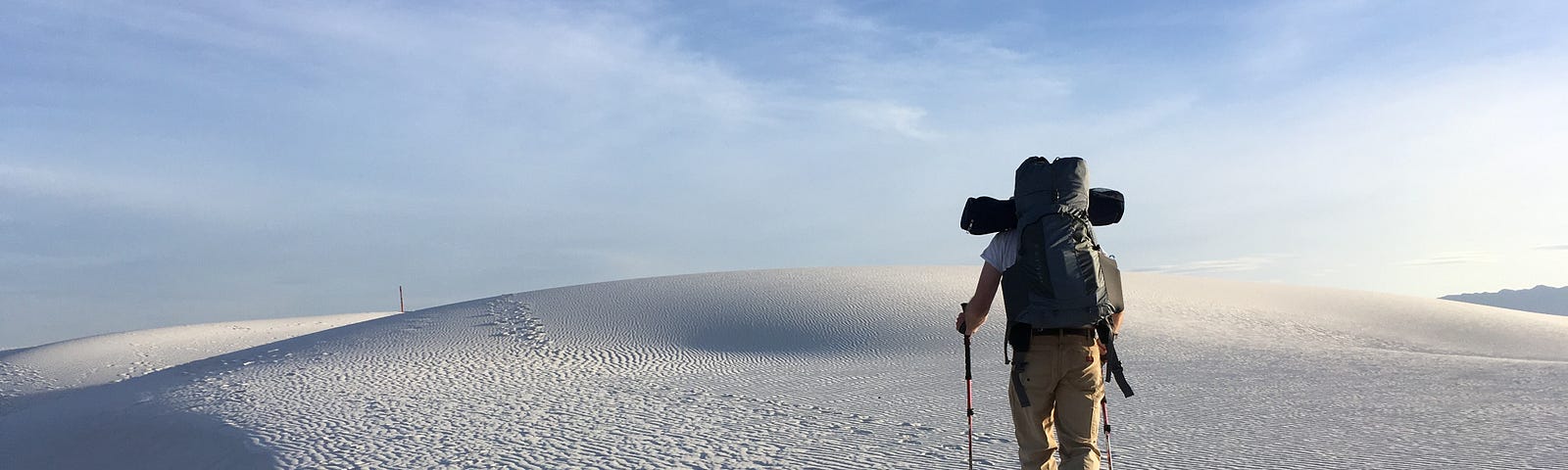 A man walking on an unknown path, leaving a trail behind.