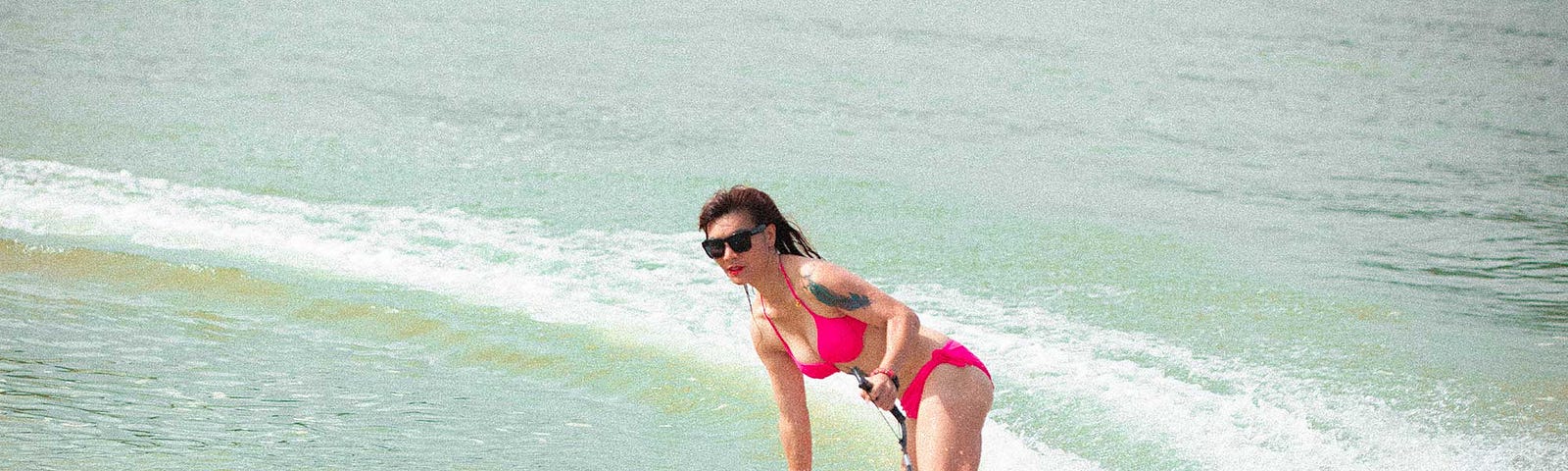 A view of a Cyrusher Thunders rider on her electric surfboard and carving the water