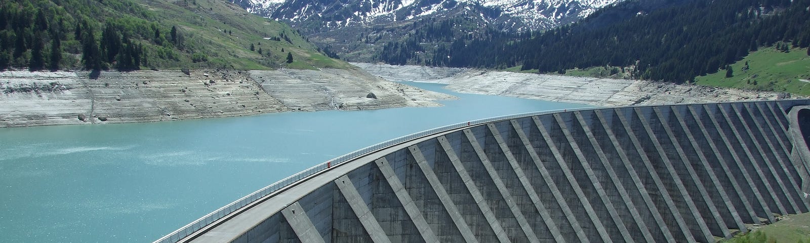 A dam with mountains in the background