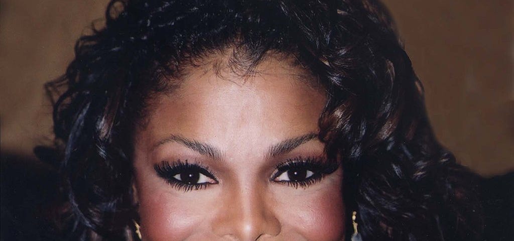 Janet Jackson smiles into the camera.