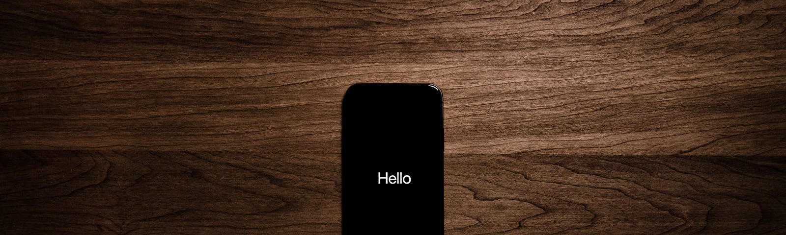 Simple white text that says “Hello” on a black iPhone background