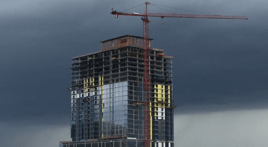 Half-built skyscraper before a dark gray sky — Moral Letters to Lucilius