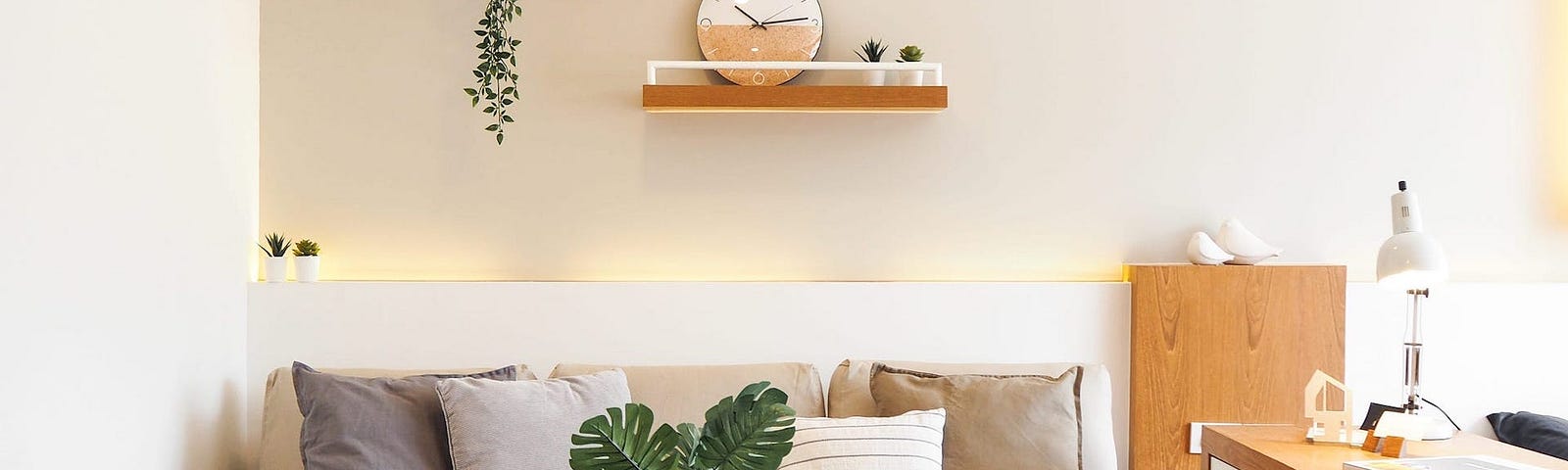 A couch next to a desk with wall decorations.