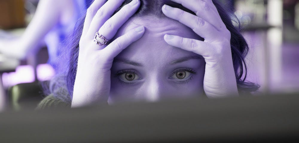 photo of young woman with her hands on her head.