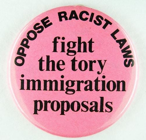 Pink badge which reads, ‘Oppose racist laws: fight the tory immigration proposals’.