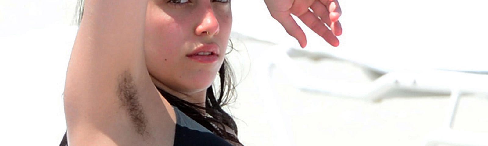 Lourdes Leon on a beach, flaunting her hairy armpit and hair-less, clean body!
