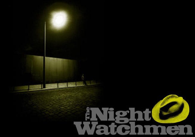 Man standing under a lamppost at night with the Night Watchmen logo under the street scene