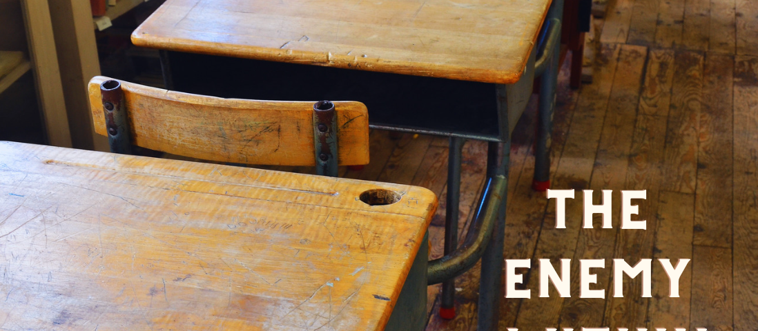 old fashioned school desk on wooden floor