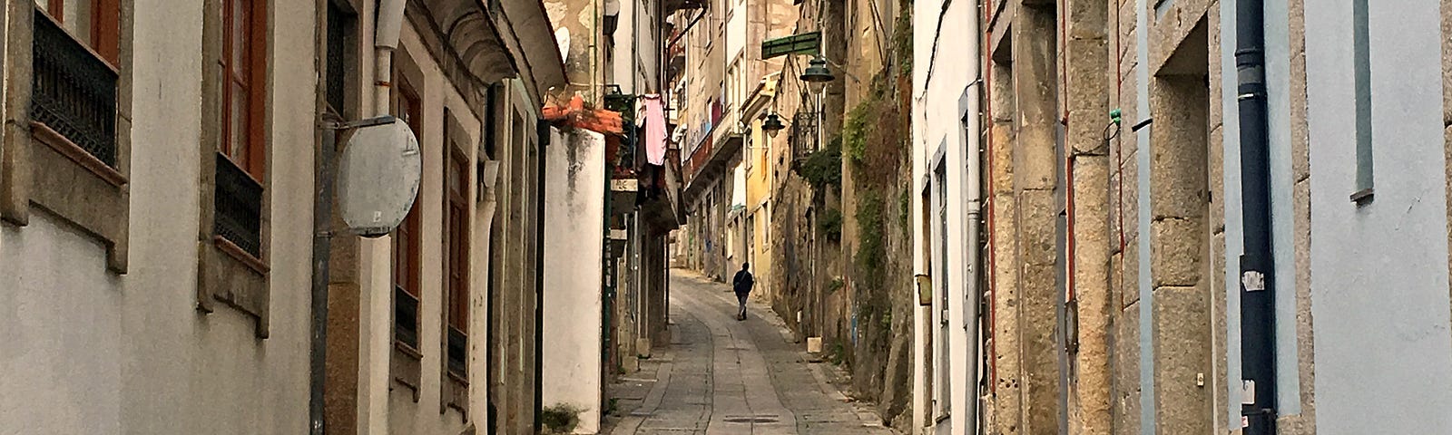 A beautiful street, narrow, with cobblestones, in N. Portugal. white-washed buildings.