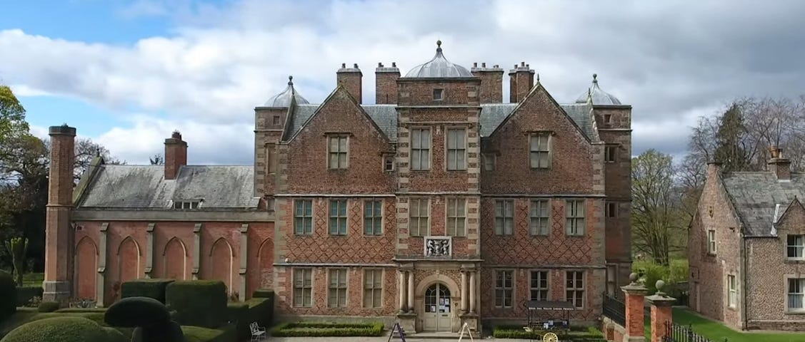 Front view over courtyard of Jacobean manor house built in red brick during the 1620s