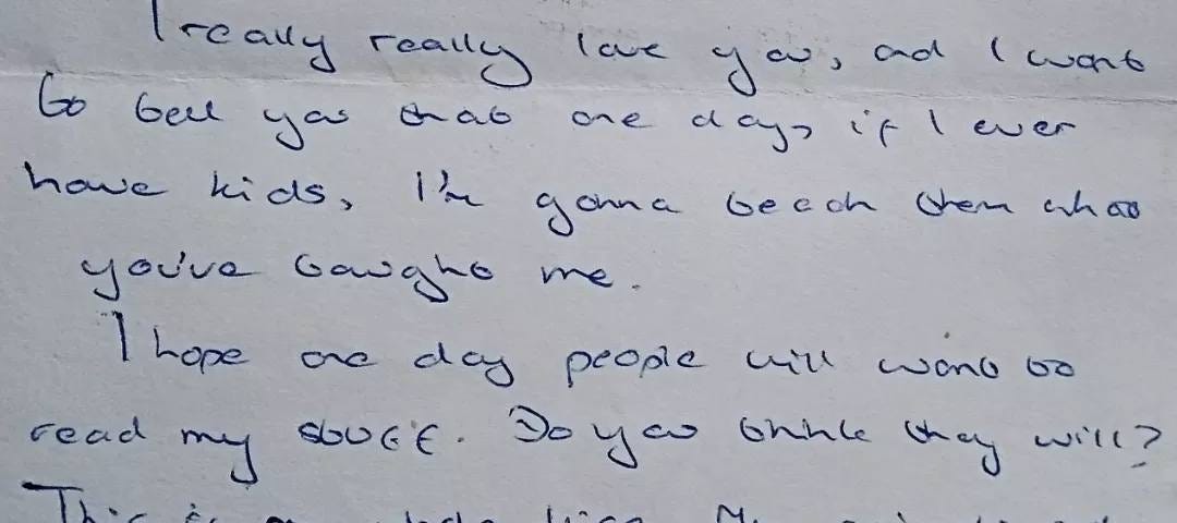 A hand-written letter in blue pen