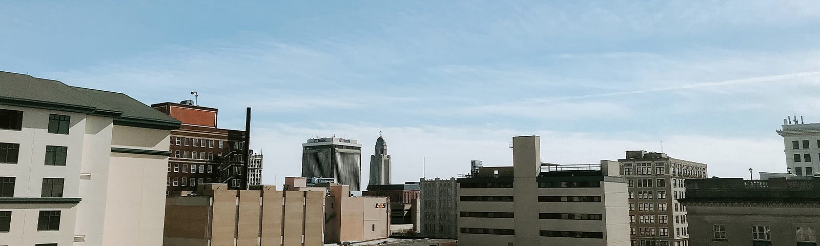 The Lincoln skyline with the state capitol in the distance on a sunny day