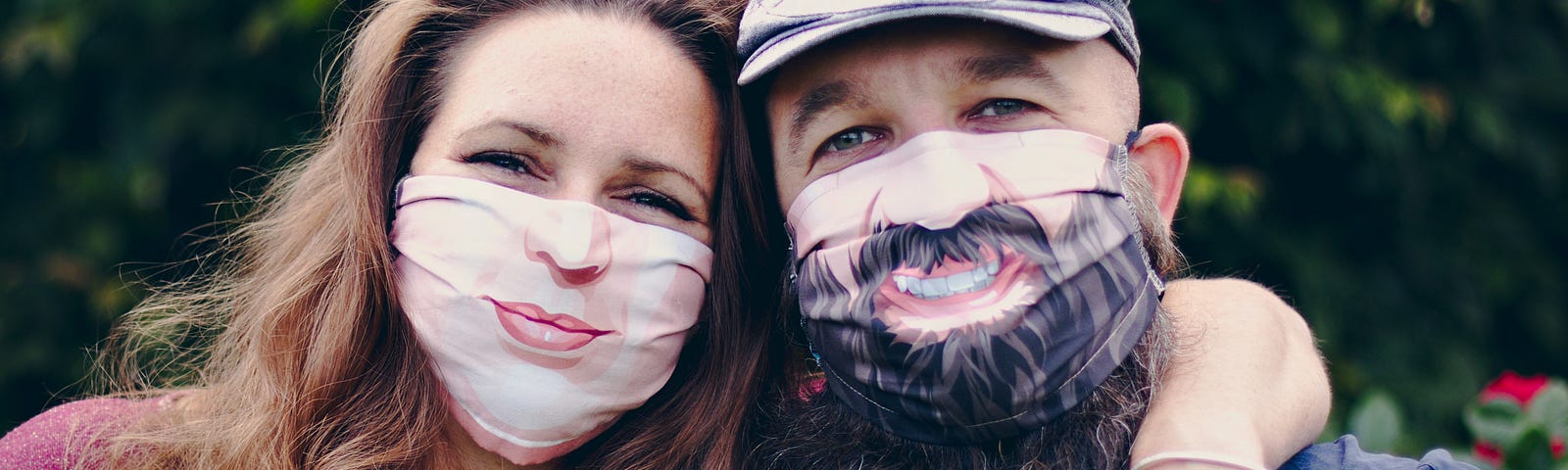 Couple poses in cloth face masks that have smiles printed on them.