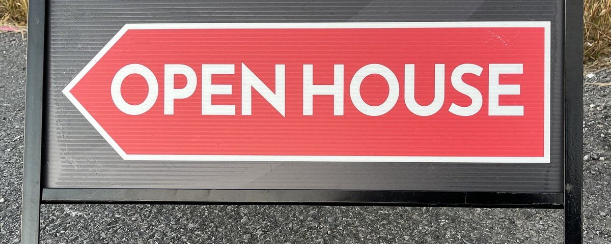 An Open House sign directing traffic to a home for sale.