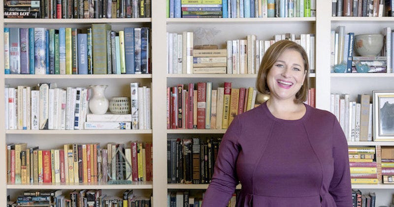 Color photo of novelist Jennifer Weiner with books