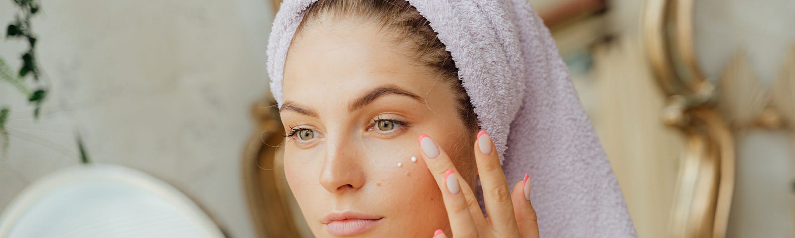 Woman With Head Towel Using Skin Cycling to be gentle with her skin while enjoying the anti-aging benefits of amazing skincare products