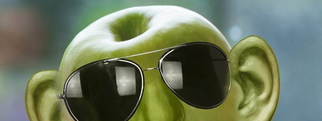 IMAGE: A funky green apple with face and ears, wearing sunglasses