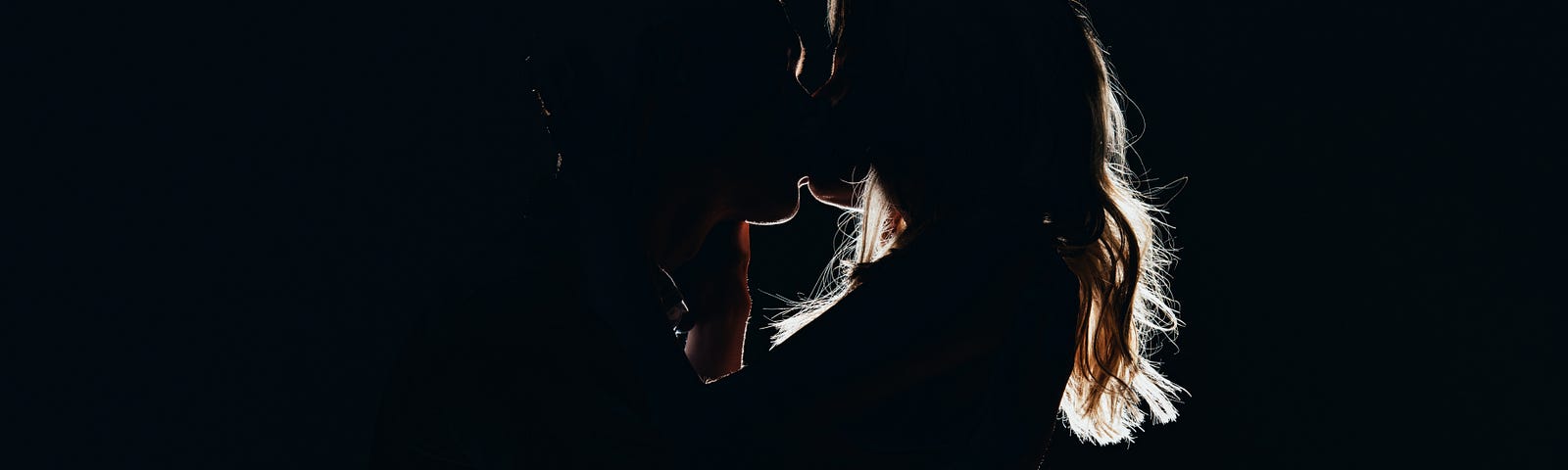 Couple kissing in the dark.