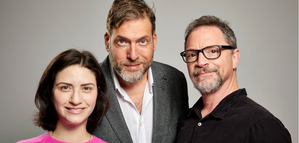 Photo of a woman and two men. co-hosts of Unorthodox.