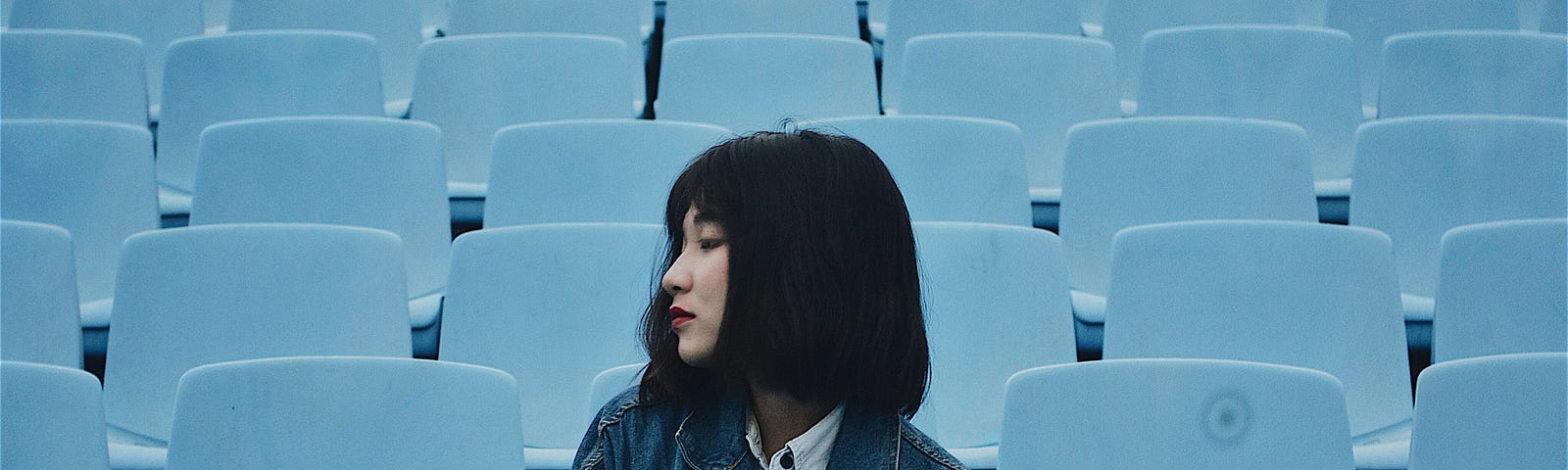 How to Boost Your Self-Discipline Every Day — Asian girl sitting on spectator stands