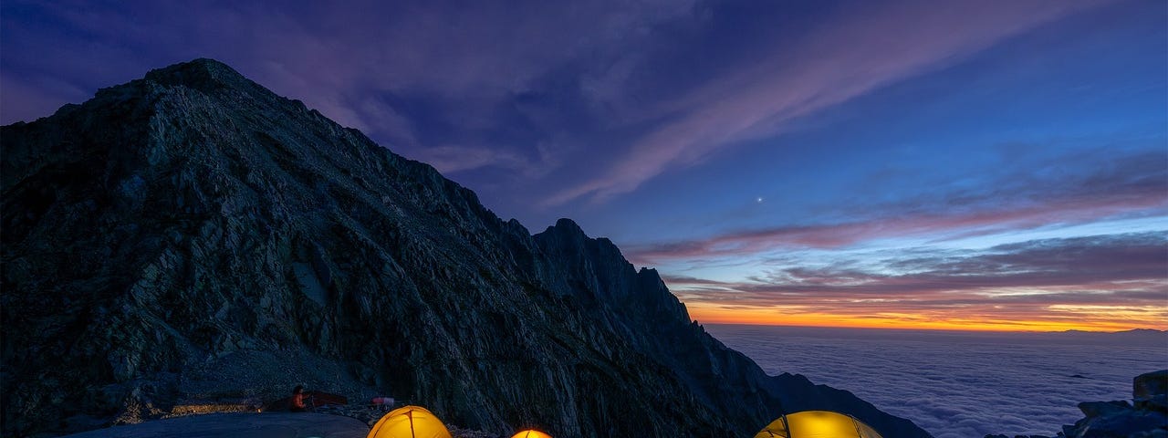 photo of camping tents illuminated