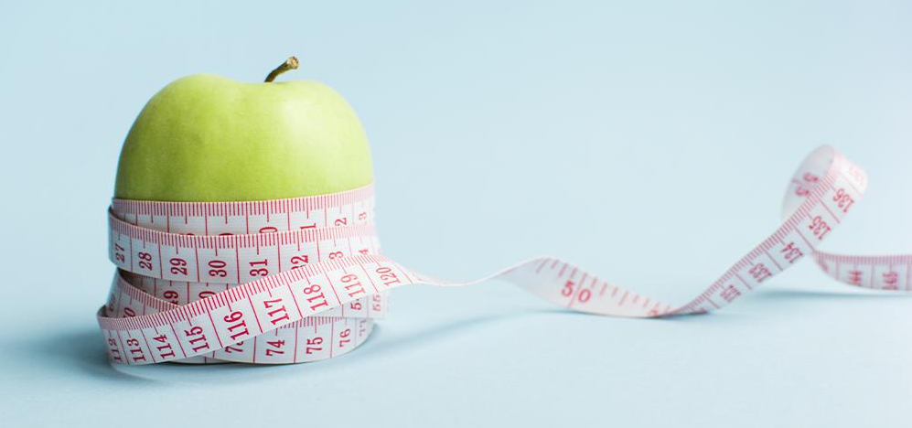 An apple wrapped with a measuring tape