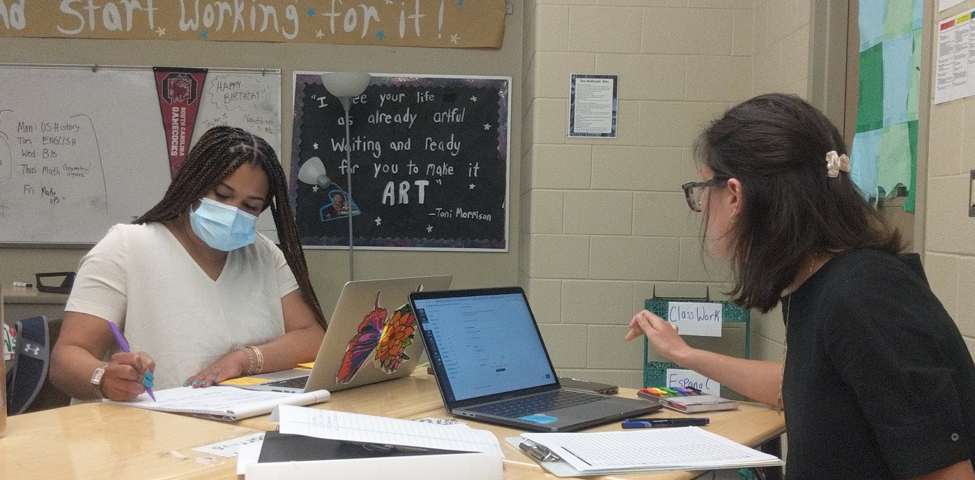 Photo of Livingston co-teachers Ms. Alexis Kelly-Darby (left) and Ms. Julia Fonshell (right) during their English 1 co-planning meeting with Dr. Watts-Freeman (not shown).