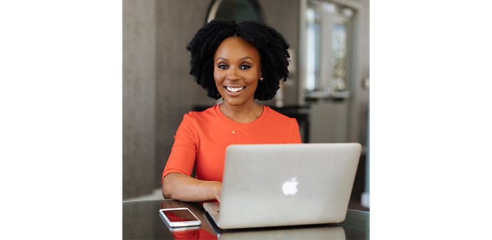 Headshot of Chianti Lomax, with laptop and phone