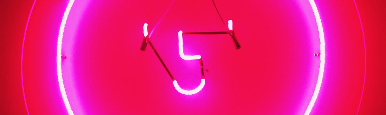 neon sign on a pink wall