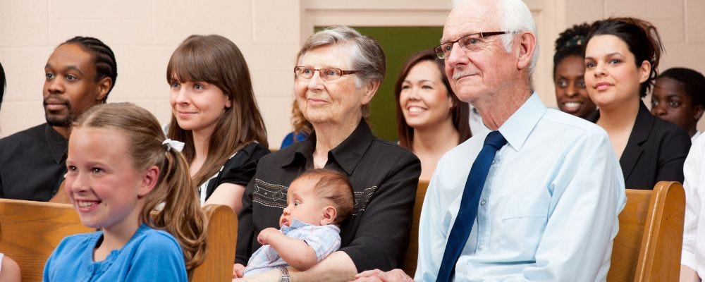 Multi-racial congregation of people from very young to elderly.