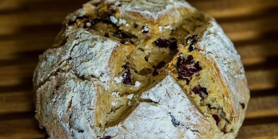 A loaf of traditional Irish soda bread with the cross cut out of the top.