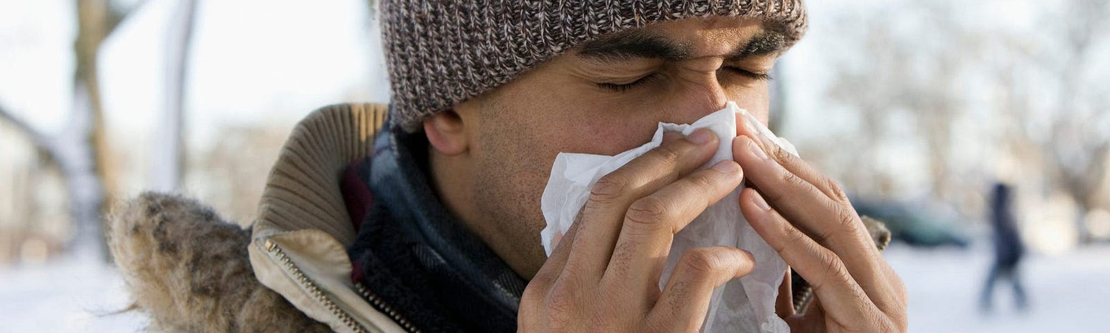 A man wipes his nose. Cold air does not kill germs or viruses.